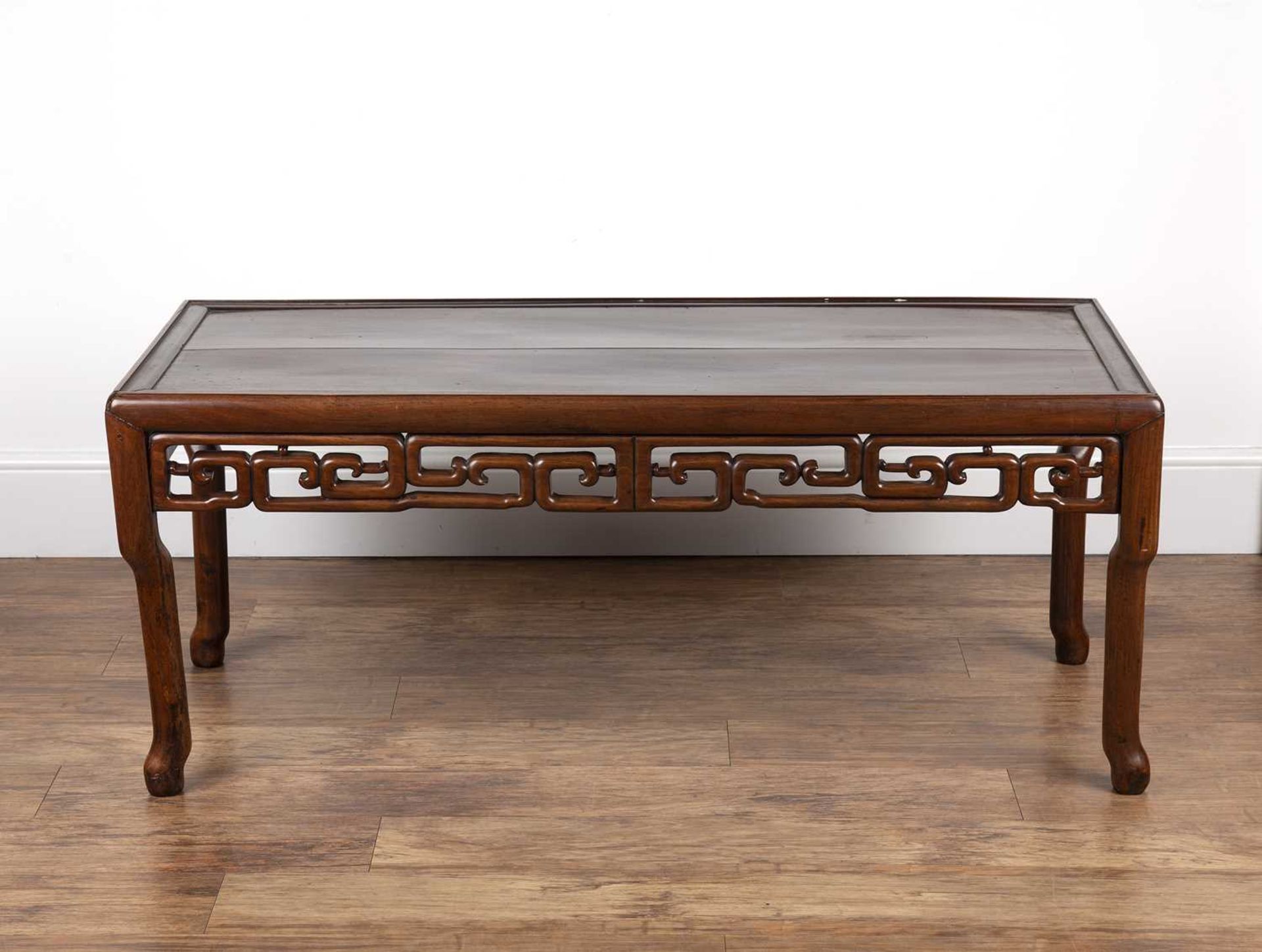 Chinese Hardwood low table 19th Century, with scroll frieze and shaped supports, 127cm long, 56cm