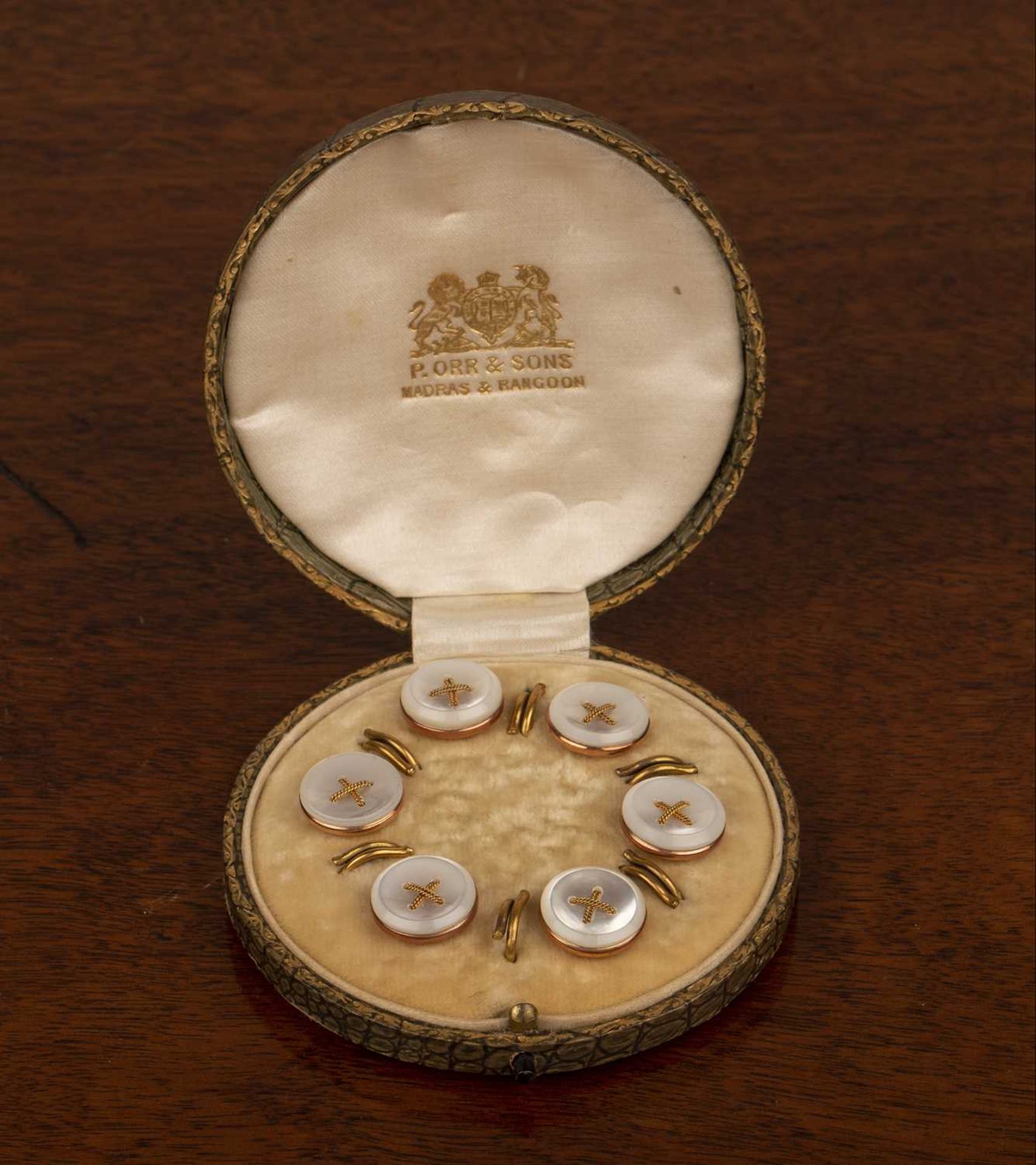 Cased 9ct gold stud set with mother of pearl button top, bearing marks for '9ct Cornelius Desormeaux