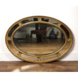 Oval gilt plaster wall mirror 19th Century, with ribbon border and carved leaf mounts, 118cm wide,