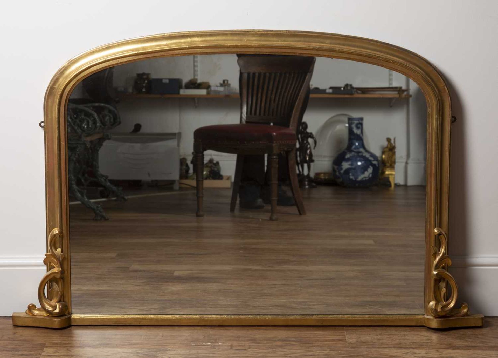 Giltwood overmantel mirror 19th Century, of fluted form with carved leaf mounts to the base, 81.