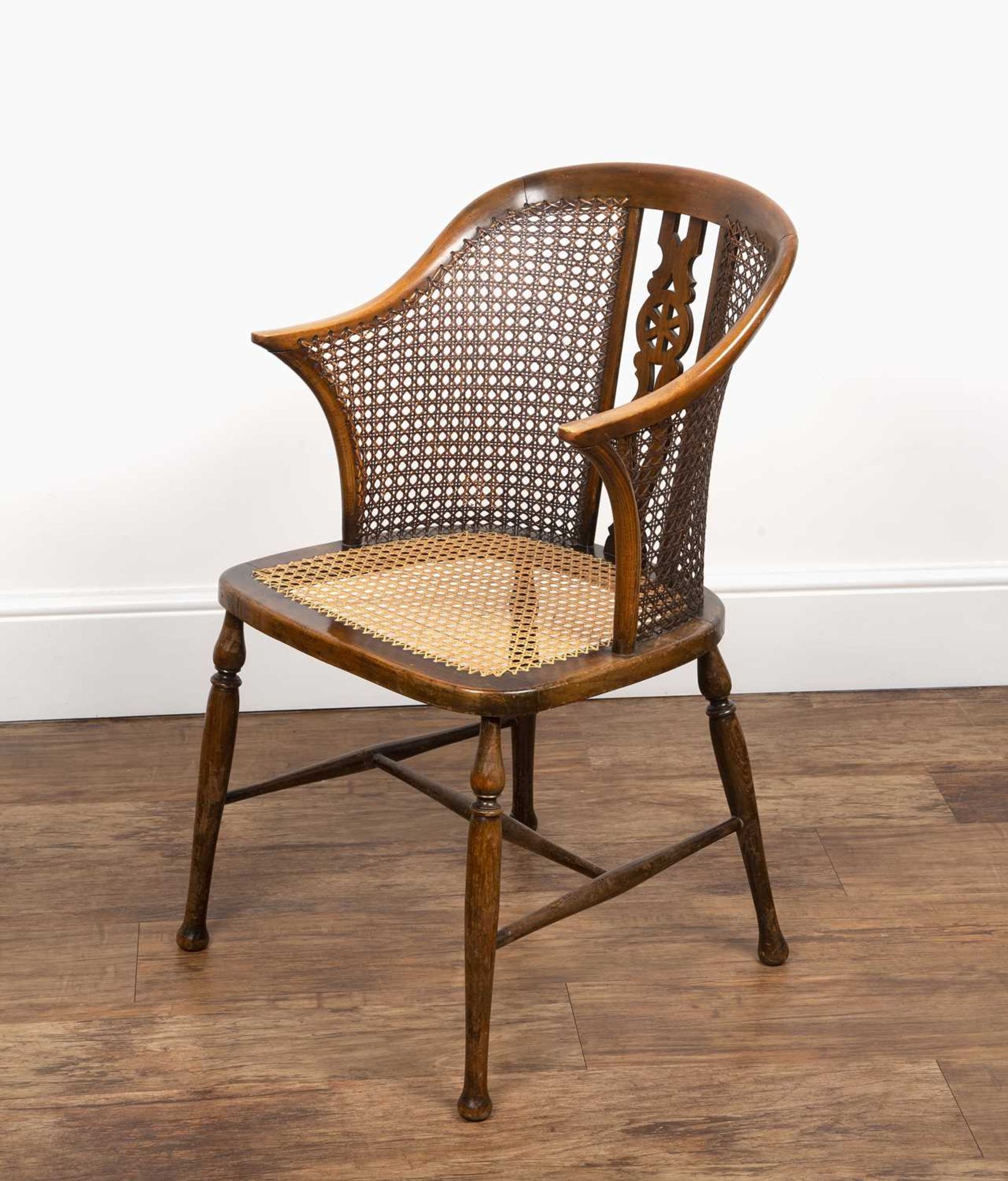 Edwardian bergere caned chair by Arthur Newbery Ltd, beech frame, with pierced wheel splat to the