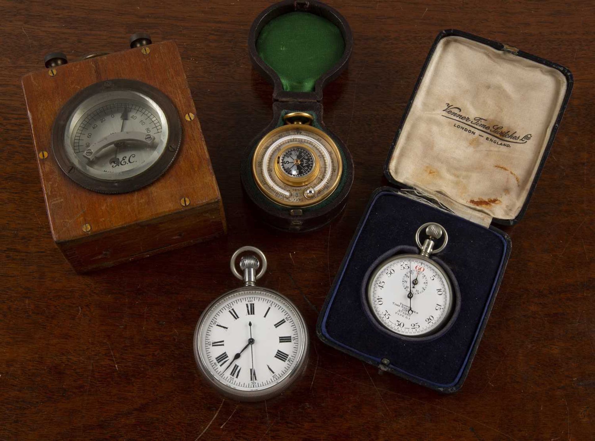 Leather-bound compensated pocket barometer unmarked, 5cm across, together with a cased stopwatch
