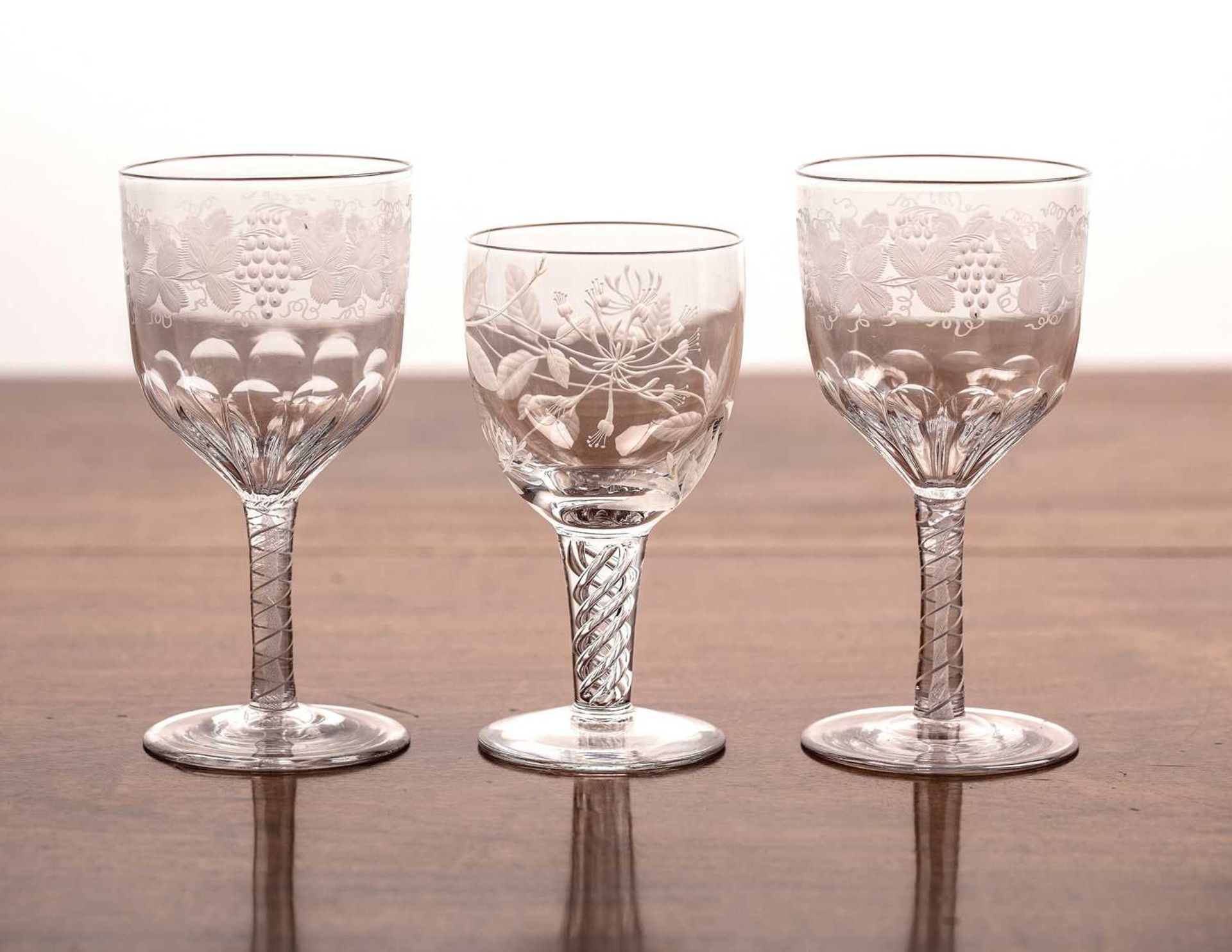 Three etched drinking glasses comprising of: a pair of 19th Century glasses with etched grapes and