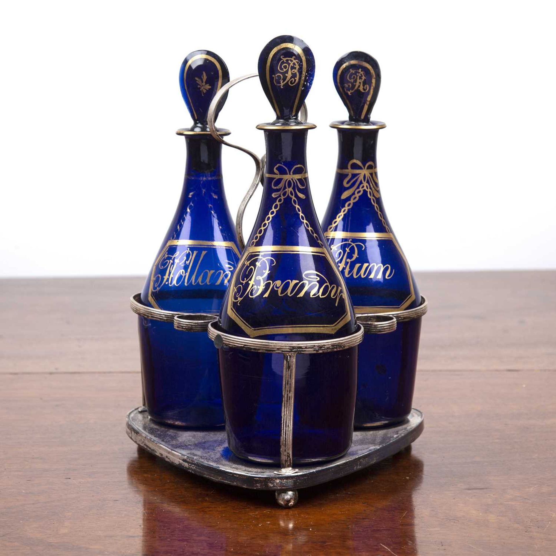 Set of three Bristol blue decanters on silver plated stand late 18th/early 19th Century, the glass