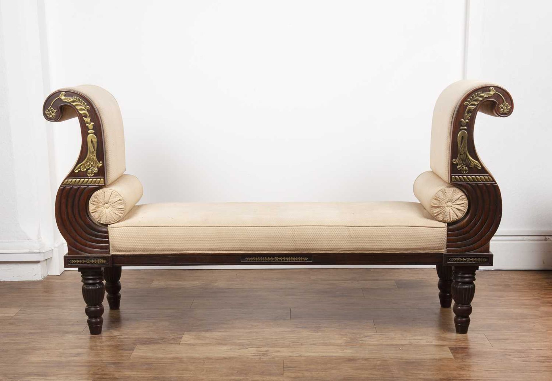 Empire style mahogany and parcel gilt large window seat with scroll arms on reeded supports with