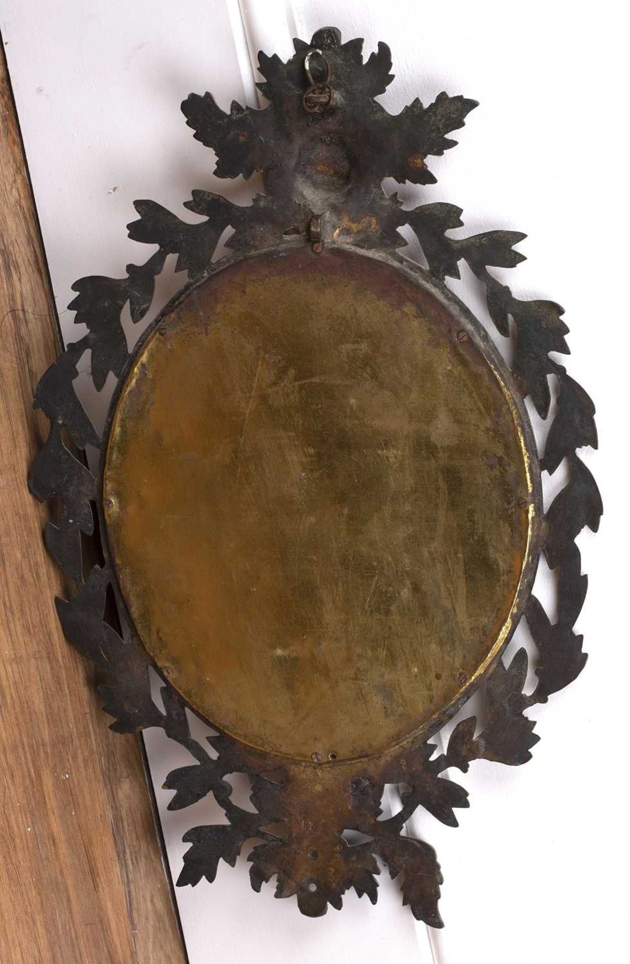 Gilt metal oval wall mirror late 19th Century, with mask and leaf border, 45cm x 31cmProbably - Image 2 of 2