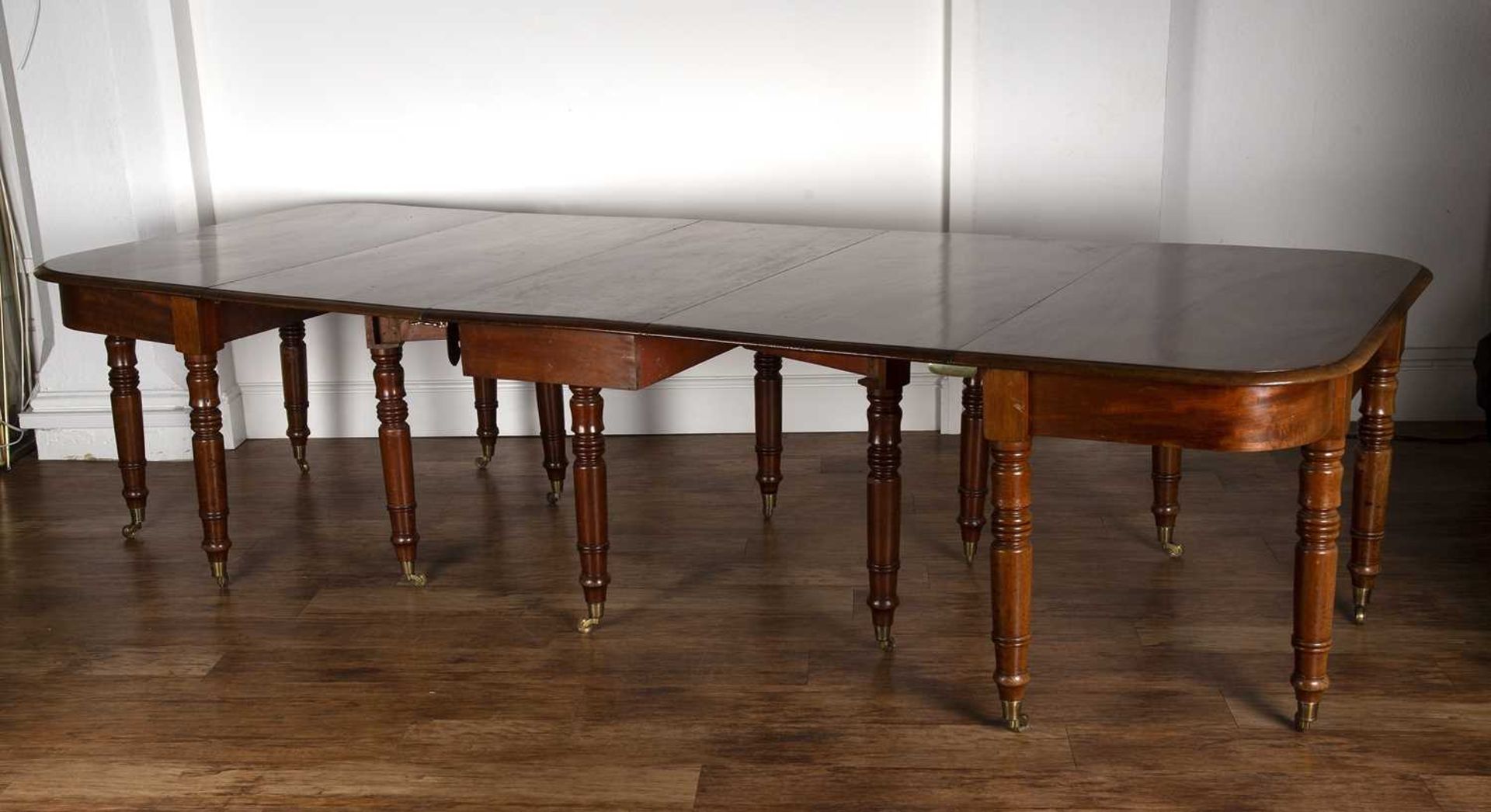 Mahogany D-end dining table 19th Century, with central drop-leaf on turned supports with brass - Image 4 of 4