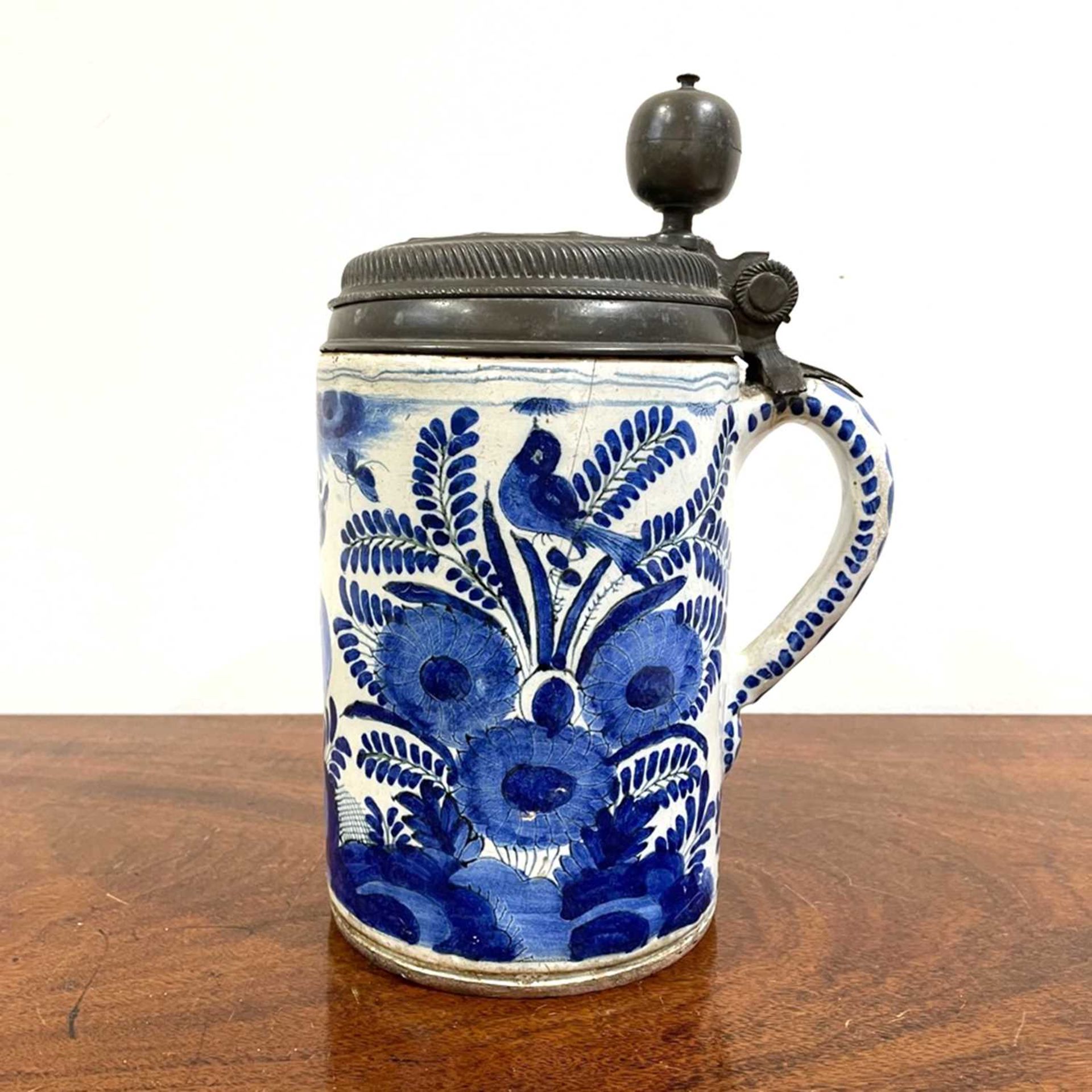 German faience ceramic tankard decorated in blue with birds, flowers, leaves etc, with pewter lid,