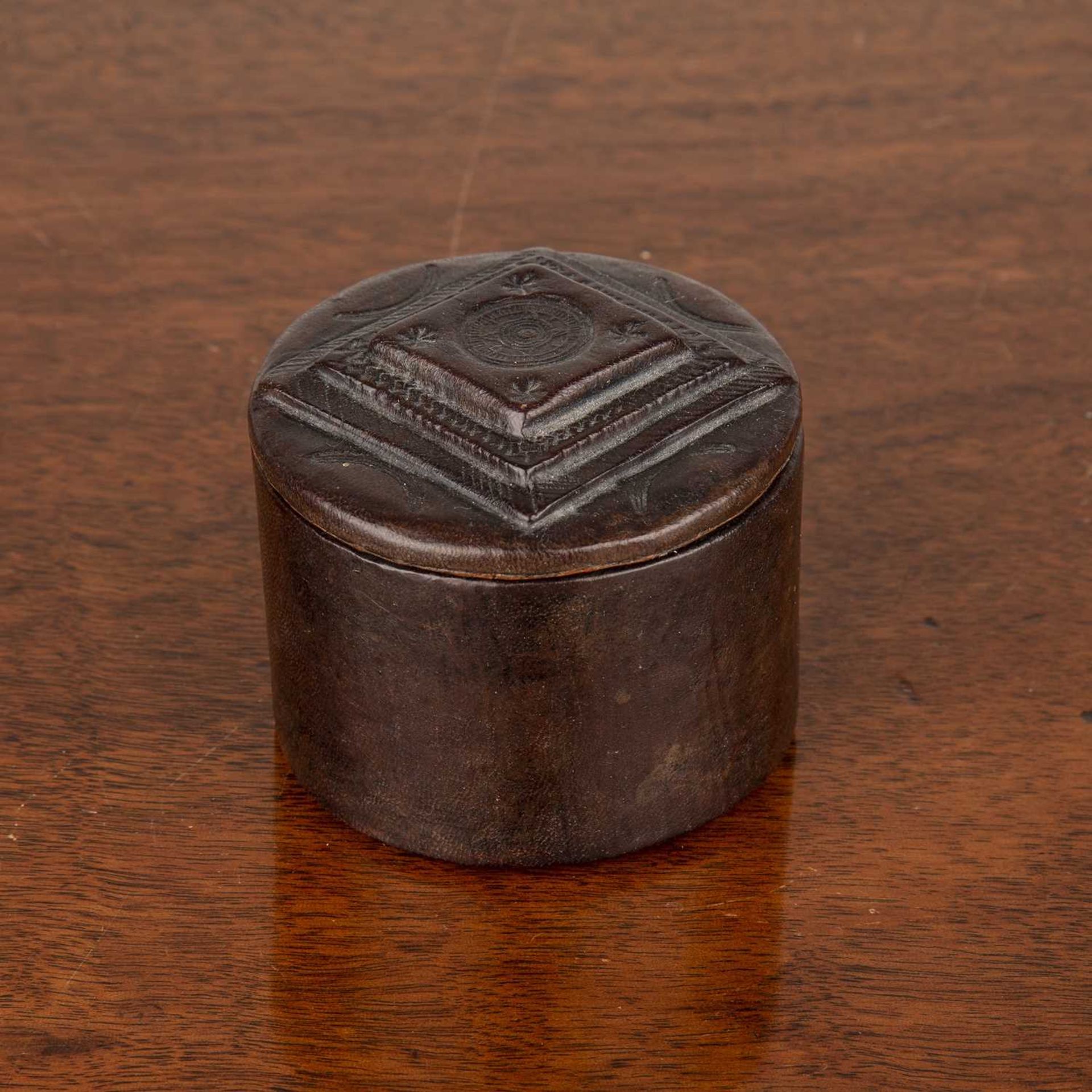 Small leather cylindrical box with impressed decoration including a compass on the lid, 6cm diameter