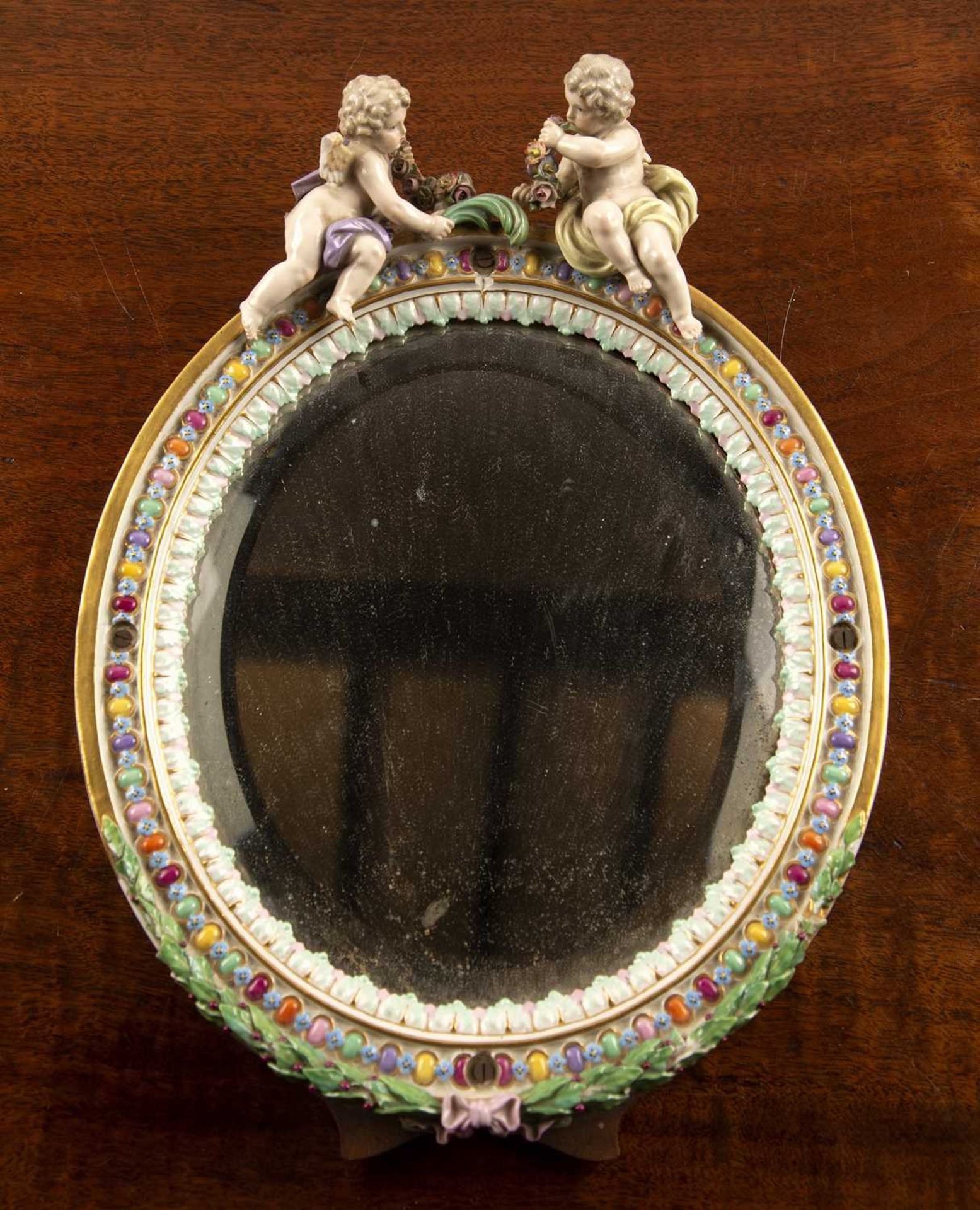Meissen oval porcelain dressing table mirror German, late 19th Century, with a coloured oval border,