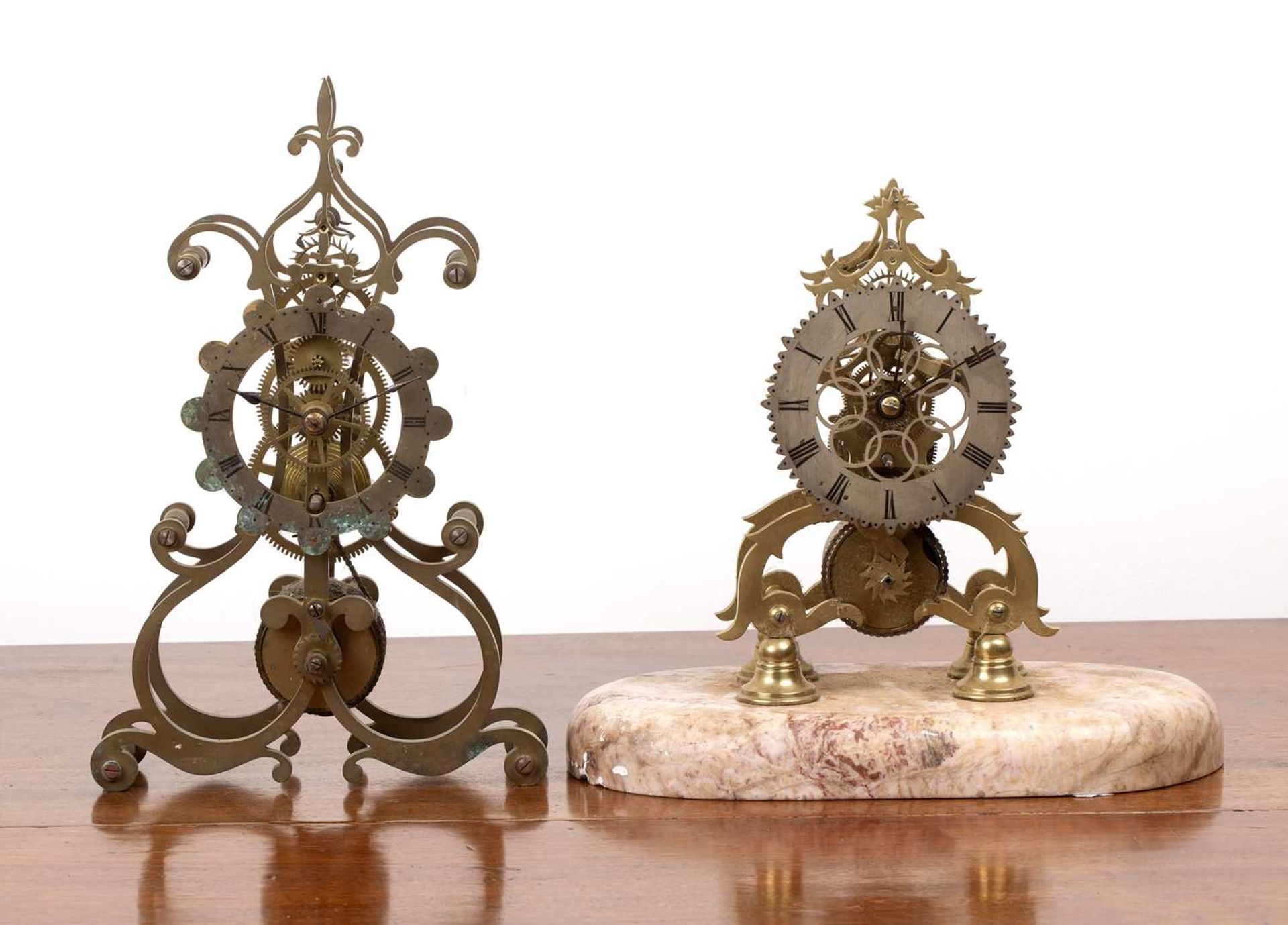 Two skeleton clocks one on an oval marble base, each with a fusee movement, 34cm and 24.5cm highNo