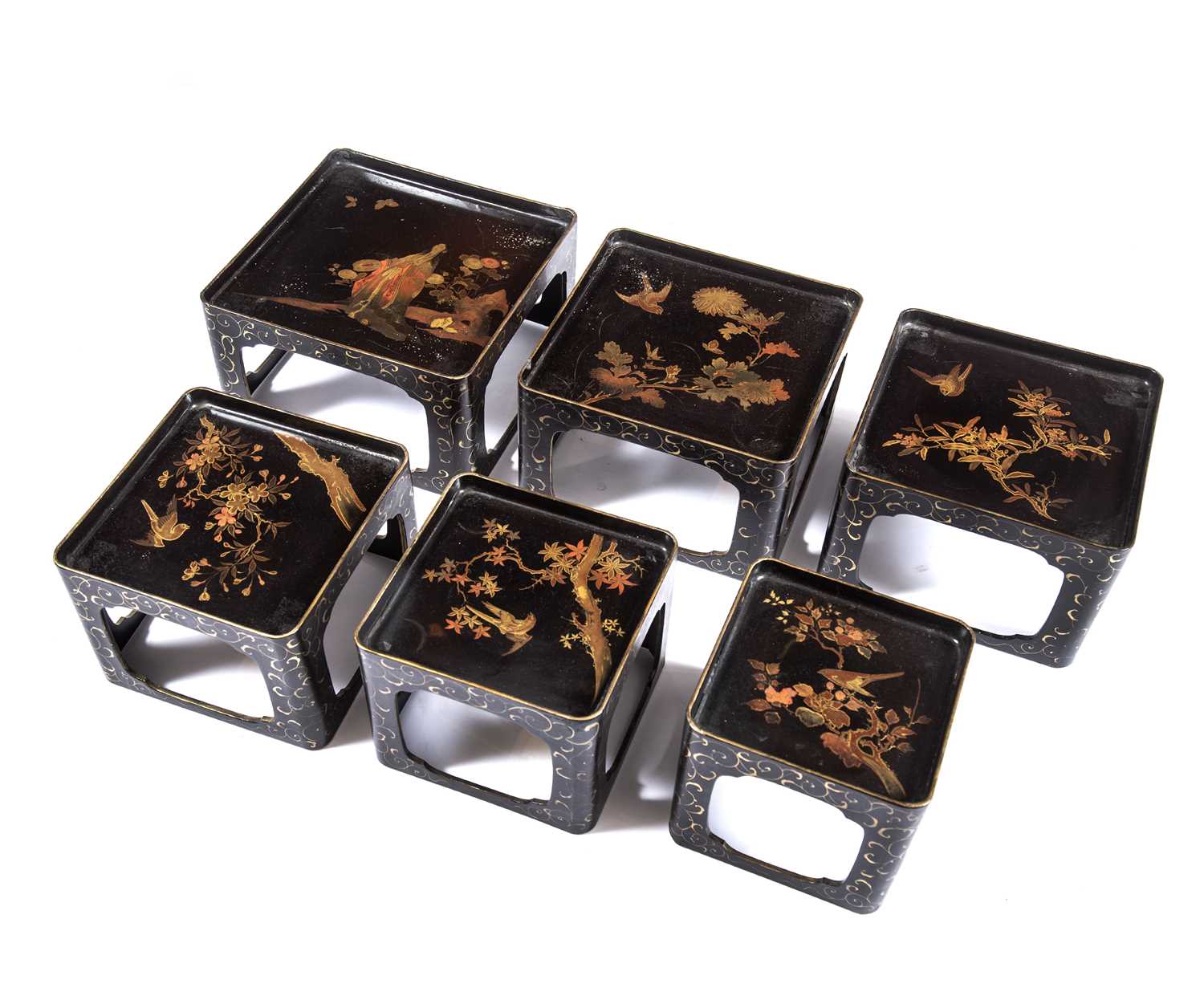A late 19th / early 20th century nest of lacquered graduated tables with japanned gilded decoration,