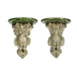 A pair of antique painted and carved wooden wall brackets each with a marbled top, scrolling leaf