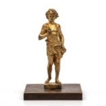 A gilt bronze model of a boy on a wooden stand, 10.5cm in height