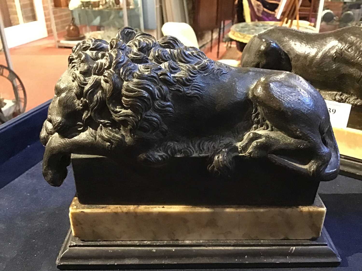 A pair of early 19th century Grand Tour bronze recumbent lions each mounted on white marble bases, - Image 8 of 10