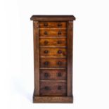 A Victorian rosewood Wellington chest of seven drawers with turned knob handles and raised on a