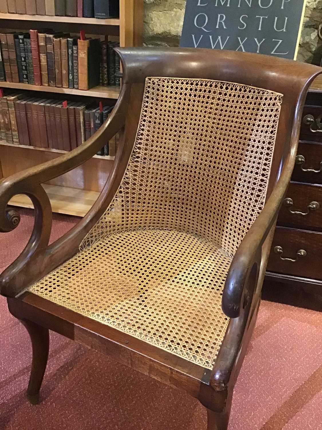 A Regency mahogany bergere library open armchair with a caned back and seat, scrolling arms, sabre - Image 7 of 11