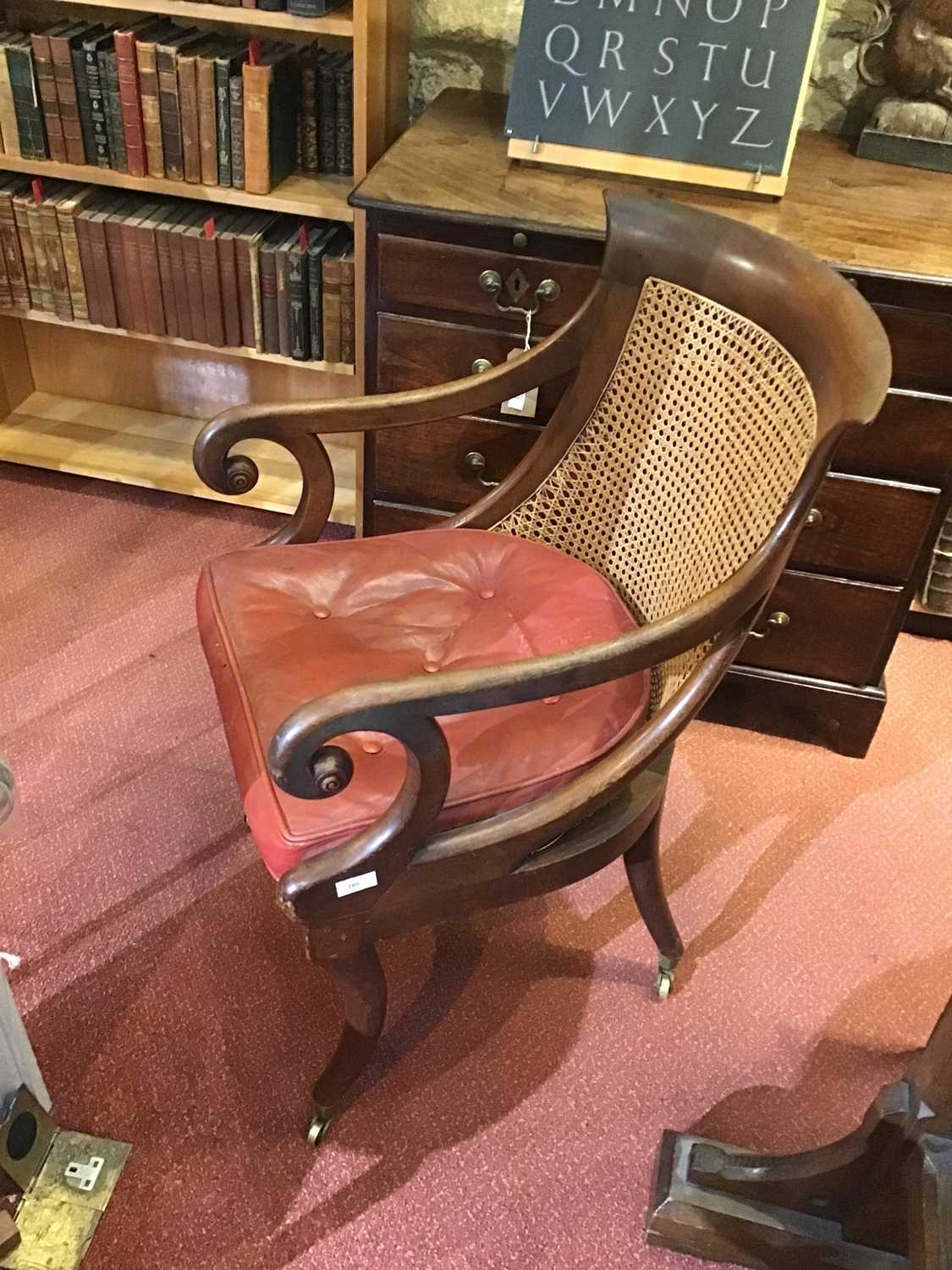 A Regency mahogany bergere library open armchair with a caned back and seat, scrolling arms, sabre - Image 5 of 11