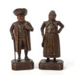 A pair of early 19th century carved pine figures depicting a man and woman, each 8cm wide x 22cm