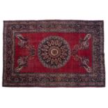 An early 20th century red ground Khurasan rug with foliate designs. 150cm x 229cm