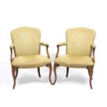 A pair of Hepplewhite style upholstered open armchairs with scrolling arms and cabriole legs, 67cm