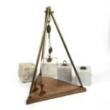A late 19th / early 20th century model of a stone pulley system with a triangular mahogany base,