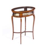 An Edwardian mahogany bijouterie table of oval form with satinwood inlay decoration, four cabriole