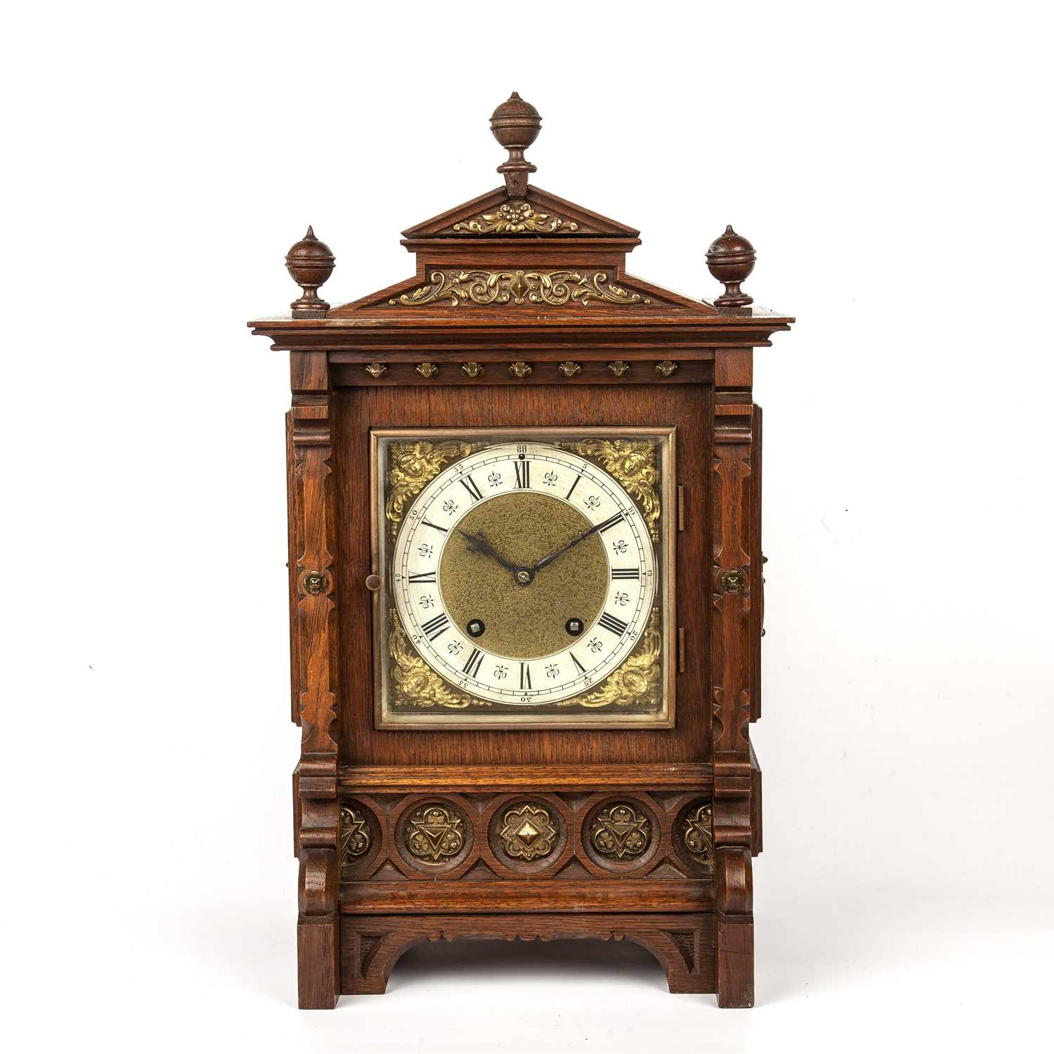 An early 20th century German mantel clock, the square brass dial with silvered Roman chapter ring,