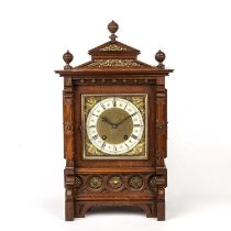 An early 20th century German mantel clock, the square brass dial with silvered Roman chapter ring,