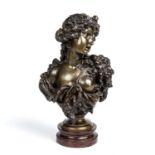 A 19th century bronze head and shoulder semi-clad female bust mounted on a red marble socle, 20cm