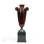 A 20th century red marble urn with a white metal collar and a grey hardstone plinth, 9cm wide x