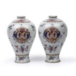 A pair of Sampson porcelain vases of baluster form with armorial decoration, 13cm wide x 22cm high