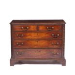 A George III mahogany chest of two short and three long drawers with brass swan neck handles,