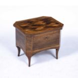 An early 19th century rosewood tea caddy having a specimen wood parquetry top, two tea cannisters