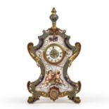 A late 19th century French gilt metal mantle clock with enamelled decoration and inset painted