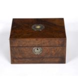 An early Victorian walnut dressing table box having a red velvet and ebonised compartmented interior