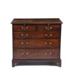 A George III mahogany chest of drawers with a brushing slide two short and three long drawers with