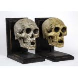 A pair of book ends of skull form, 14cm wide x 20cm deep x 22cm high
