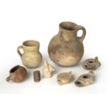 A group of ancient artefacts to include three Roman oil lamps, a figure riding a boar, a small