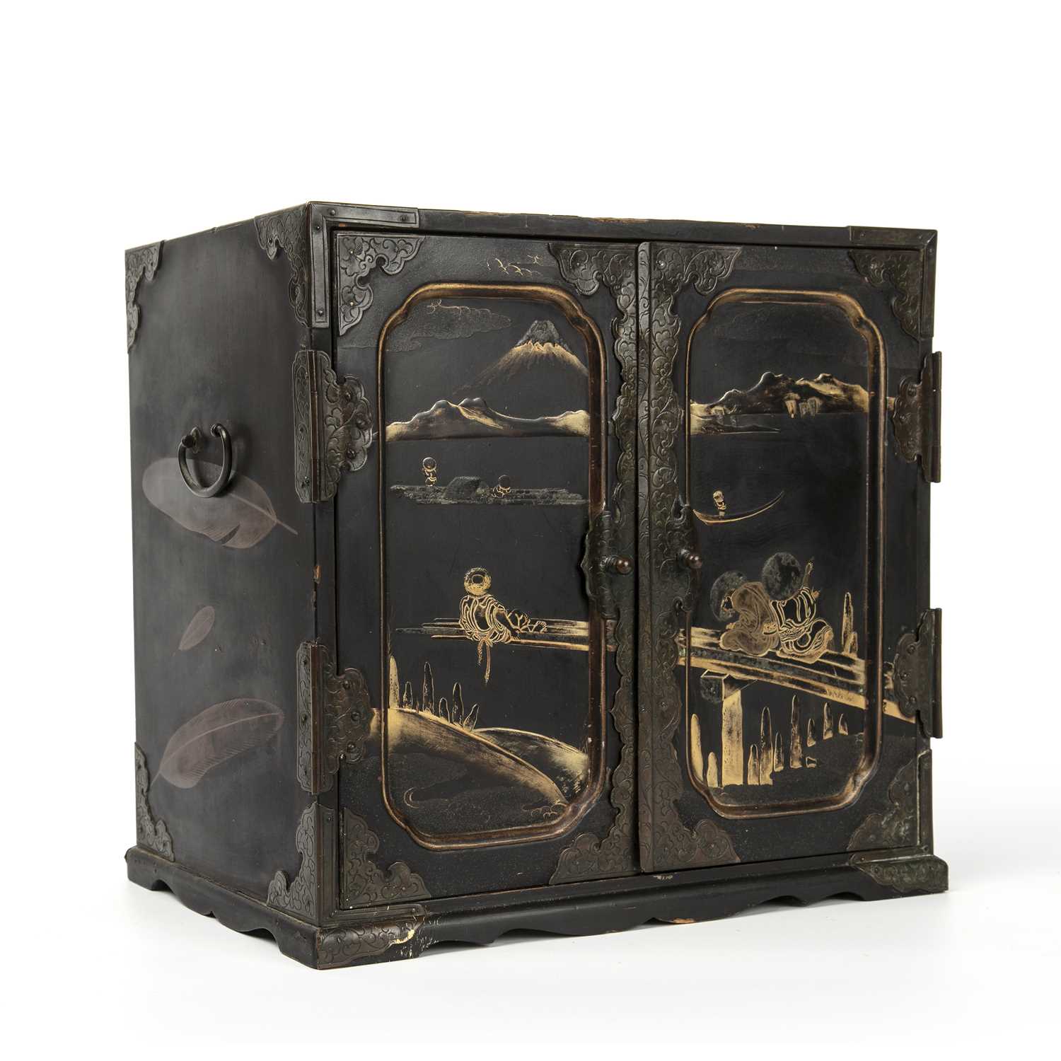 An antique Japanese lacquered table cabinet with gilded decoration, twin panelled doors opening to
