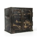 An antique Japanese lacquered table cabinet with gilded decoration, twin panelled doors opening to