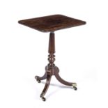 A William IV rosewood tripod table with a rectangular top, a reeded stem and sabre legs