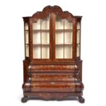 A 19th century Dutch marquetry Bombe cabinet with glazed doors above three drawers having rococo