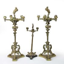 A pair of Regency gilt metal five-branch candelabra with heron finials, lions mask mounts and