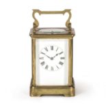 A late 19th / early 20th century brass carriage clock the enamelled dial with roman numerals, having