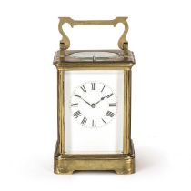 A late 19th / early 20th century brass carriage clock the enamelled dial with roman numerals, having