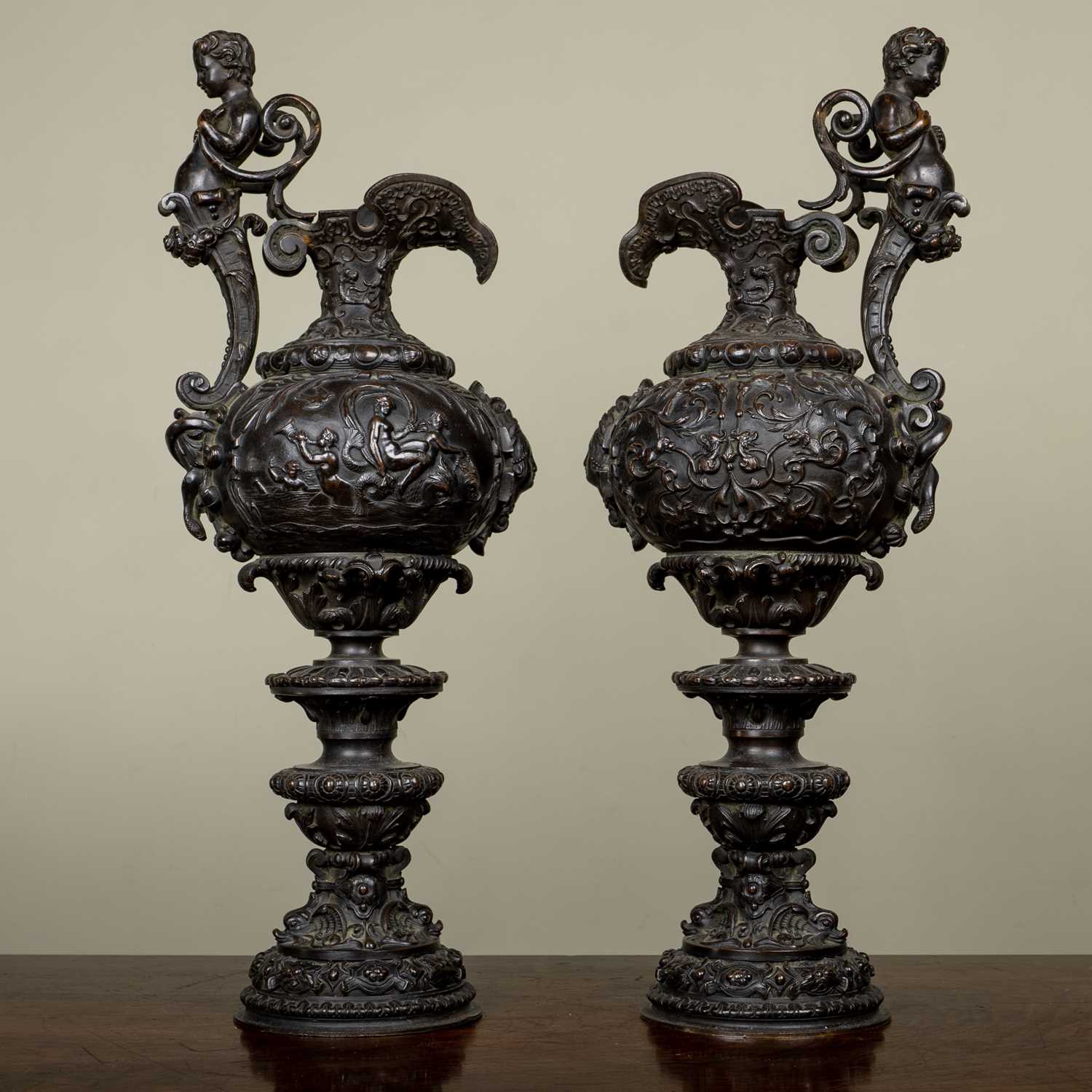 A pair of antique French Renaissance-style bronze ewers, decorated with classical scenes, 50.5cm