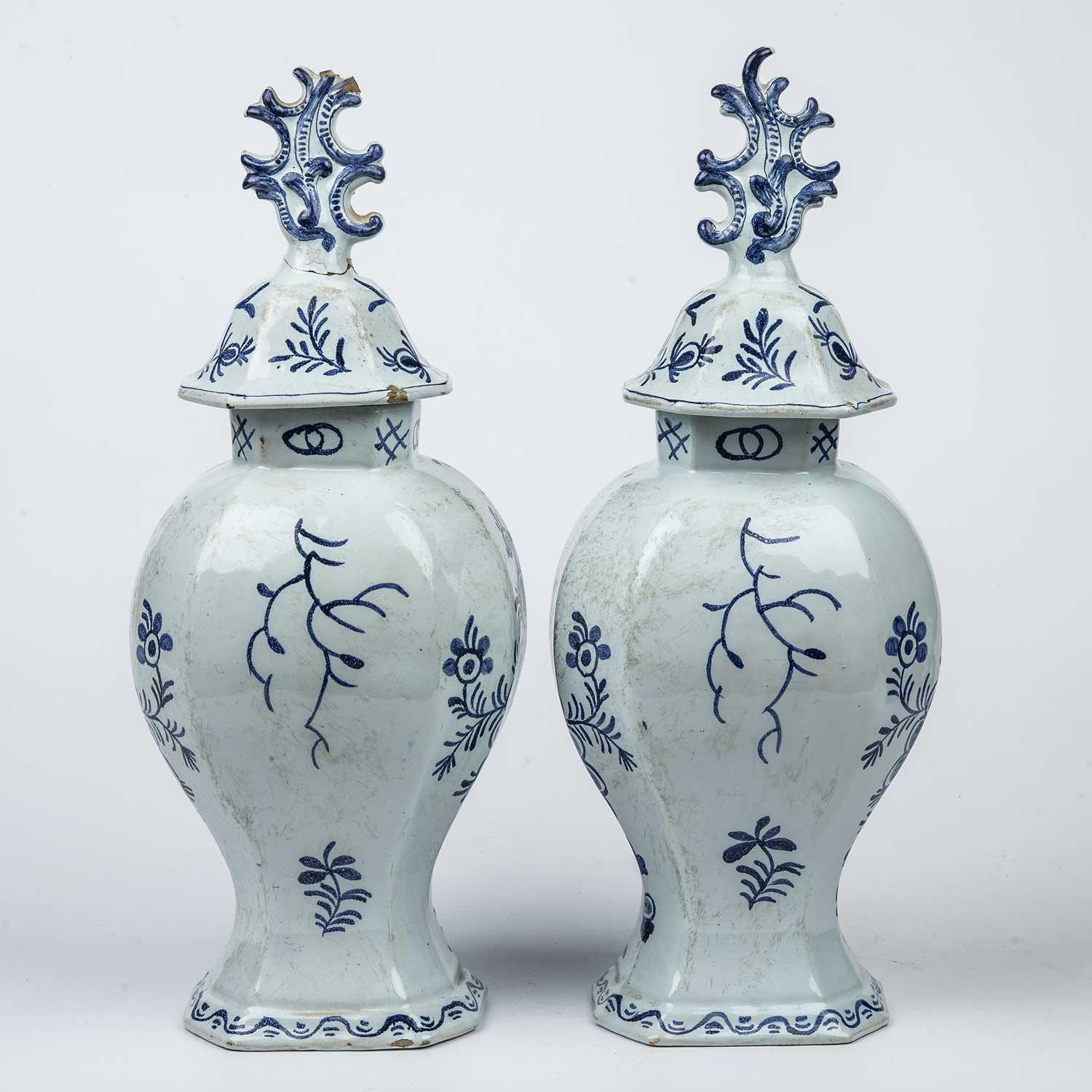 A pair of 19th century tin glazed vases and covers with blue and white foliate decoration, each 15cm - Image 2 of 3