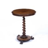An early Victorian mahogany occasional table with a twisted stem and triform base. 56cm diameter