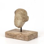 A Roman marble female head, 4cm wide x 6cm highSurface wear, marks and losses, as seen
